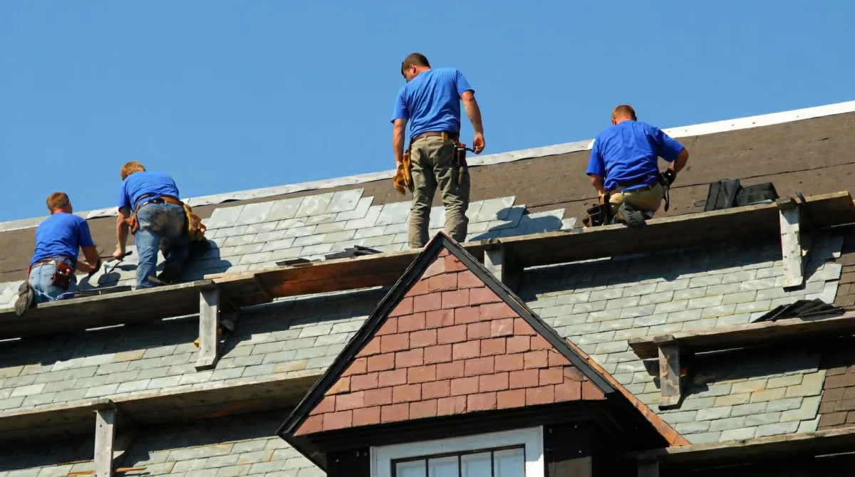 Roof replacement in progress with a team of professional contractors installing new shingles on a residential home in Long Beach, CA